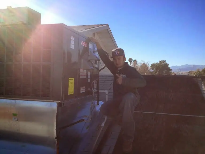 HVAC technician performing HVAC Inspection on a rooftop unit in Windsor